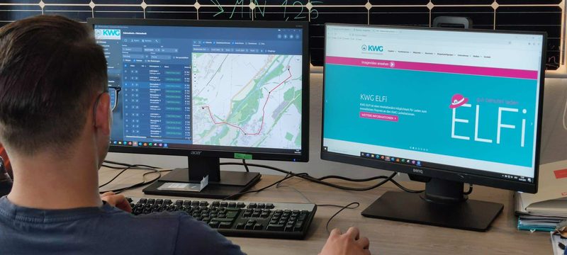 KWG employee reviewing digital trip records and vehicle routes at a workstation